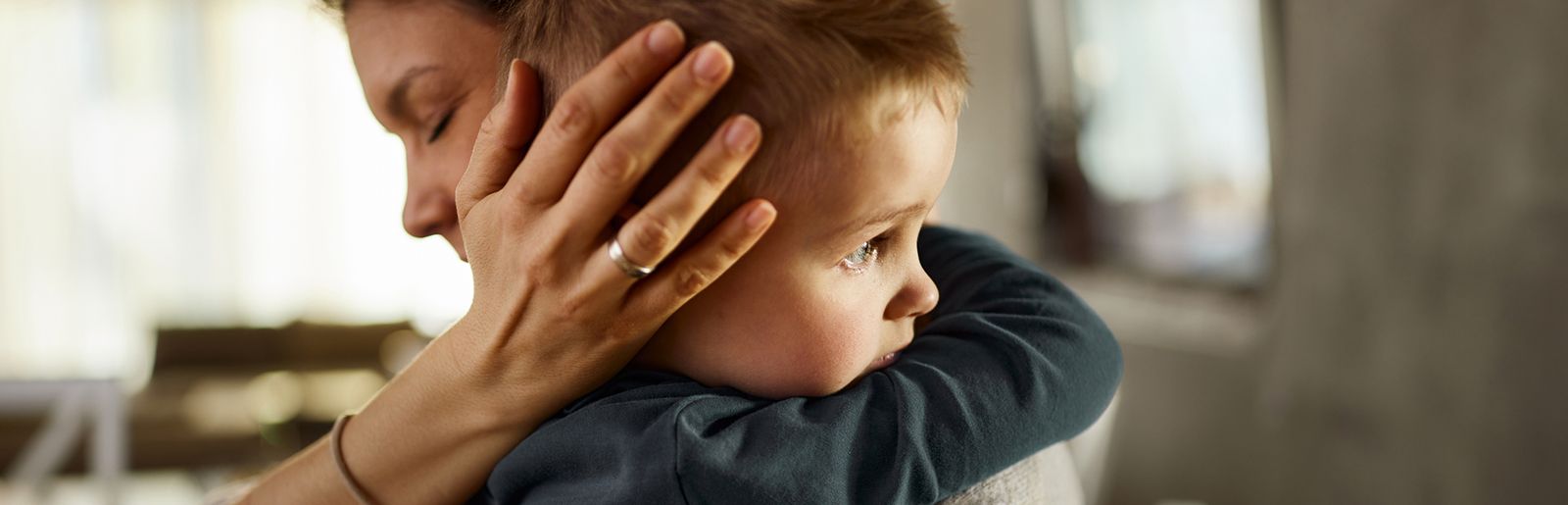 A mother holding her young child close