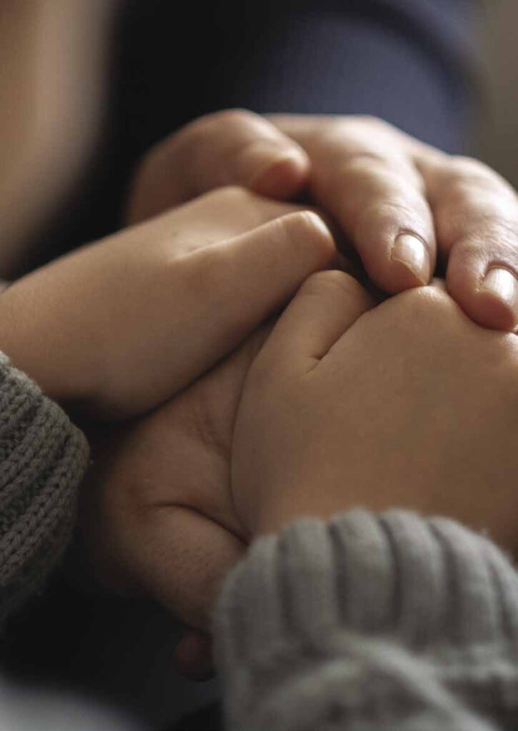 Two people holding hands in comfort